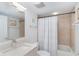 Well-lit bathroom features a large mirror, white vanity, and shower with decorative tile surround at 50 Meredith Dr # 9, Englewood, FL 34223