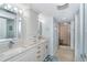 Bright bathroom featuring double sinks, granite countertops, and a walk-in shower at 50 Meredith Dr # 9, Englewood, FL 34223