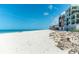 Stunning beach with white sand and clear blue water along the shoreline near the building at 50 Meredith Dr # 9, Englewood, FL 34223