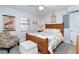 Cozy bedroom with neutral walls, wood-look furniture, and bright windows at 50 Meredith Dr # 9, Englewood, FL 34223