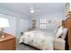 Bedroom featuring a ceiling fan, butterfly themed bedding, and a comfortable sitting chair at 50 Meredith Dr # 9, Englewood, FL 34223