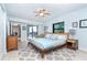 Comfortable bedroom with sliding door to the balcony, ocean view, and a stylish rug at 50 Meredith Dr # 9, Englewood, FL 34223