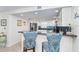 Bright, renovated kitchen with white cabinets, modern appliances, and blue backsplash at 50 Meredith Dr # 9, Englewood, FL 34223