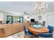 Spacious living room with dining area, stylish furniture, and access to outdoor balcony at 50 Meredith Dr # 9, Englewood, FL 34223