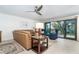 Cozy living room with comfortable seating and sliding glass doors to the balcony with water views at 50 Meredith Dr # 9, Englewood, FL 34223