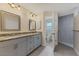 Well-lit bathroom with double vanity, granite countertops, and modern tiled shower at 5781 Elton Rd, Venice, FL 34293