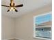 Cozy bedroom features a ceiling fan, natural light from window at 5781 Elton Rd, Venice, FL 34293