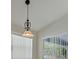 Close-up of an ornate chandelier lighting up the dining area near a window at 5781 Elton Rd, Venice, FL 34293