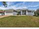 Charming single-story home with a gray exterior, well-manicured lawn and two-car garage at 5781 Elton Rd, Venice, FL 34293