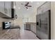 Modern kitchen featuring stainless steel appliances, granite countertops, and stylish gray cabinets at 5781 Elton Rd, Venice, FL 34293