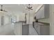 Modern kitchen with gray cabinets, granite countertops, stainless steel appliances, and tiled floor at 5781 Elton Rd, Venice, FL 34293