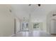 Open living room featuring tile floors, double doors, high ceilings, and contemporary light fixtures at 5781 Elton Rd, Venice, FL 34293