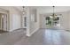 Bright living room with tile floors, modern light fixture, and large windows at 5781 Elton Rd, Venice, FL 34293