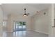 Spacious living room featuring tile flooring, ceiling fan, and sliding glass doors to outdoor area at 5781 Elton Rd, Venice, FL 34293
