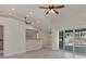 Bright living room with tile floors, ceiling fan, and sliding doors to outdoor area, showcasing modern design at 5781 Elton Rd, Venice, FL 34293