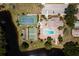 Aerial view of community amenities featuring a pool, tennis court, and beautiful landscaping at 609 Deerwood Ave, Englewood, FL 34223