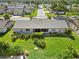 Aerial view of the home showing the backyard landscaping and a view of the street at 609 Deerwood Ave, Englewood, FL 34223