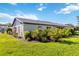 Well-maintained backyard featuring lush landscaping and healthy green grass at 609 Deerwood Ave, Englewood, FL 34223