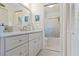 Bathroom showcasing a vanity with drawers, a toilet, and a shower with glass doors at 609 Deerwood Ave, Englewood, FL 34223