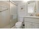 Bathroom featuring a glass enclosed shower, white tiled walls, and a white vanity at 609 Deerwood Ave, Englewood, FL 34223