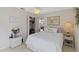 Bright bedroom showcasing a queen bed with white linens, soft decor, and a ceiling fan at 609 Deerwood Ave, Englewood, FL 34223