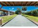 Well-maintained bocce ball court near a serene lake, shaded by palm trees for outdoor fun at 609 Deerwood Ave, Englewood, FL 34223