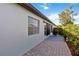 Exterior view showcasing a paver patio, lush landscaping and a neutral color palette at 609 Deerwood Ave, Englewood, FL 34223