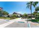 Well-maintained community building featuring beautiful landscaping, palm trees, and accessible parking at 609 Deerwood Ave, Englewood, FL 34223