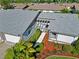 Aerial front exterior showcasing walkway and landscaped grounds including mulch and bushes at 609 Deerwood Ave, Englewood, FL 34223