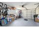 Spacious two-car garage with ample storage space, bikes, and epoxy flooring at 609 Deerwood Ave, Englewood, FL 34223