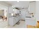 Bright and modern kitchen featuring white cabinets, marble countertops, stainless steel appliances, and tiled floor at 609 Deerwood Ave, Englewood, FL 34223
