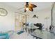 Enclosed lanai featuring a glass table, tropical ceiling fan and access to the kitchen at 609 Deerwood Ave, Englewood, FL 34223