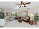 Cozy living room featuring comfortable seating, natural light, and stylish decor with ceiling fan at 609 Deerwood Ave, Englewood, FL 34223