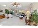 Bright living room with tropical decor, ceiling fan, comfortable seating, and lots of natural light at 609 Deerwood Ave, Englewood, FL 34223