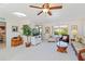 Bright living room featuring comfortable seating, natural light, and stylish decor with ceiling fan at 609 Deerwood Ave, Englewood, FL 34223