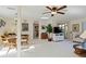 Open-concept living room featuring light walls, ceiling fan, a dining area, and sliding doors to the outside at 609 Deerwood Ave, Englewood, FL 34223