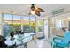 Sunroom showcasing a table with chairs, outdoor access, and many windows for natural light at 609 Deerwood Ave, Englewood, FL 34223