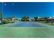 Outdoor tennis court in great condition surrounded by green landscaping perfect for recreation at 609 Deerwood Ave, Englewood, FL 34223