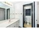Bathroom features a granite vanity, a large mirror, and a toilet room at 7059 Quigley St, Englewood, FL 34224