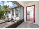 Spacious foyer with tile flooring leading to living area with hardwood floors and a view of lush landscaping at 7059 Quigley St, Englewood, FL 34224