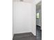 Bright hallway with gray wood flooring, white walls, and white trim at 7059 Quigley St, Englewood, FL 34224
