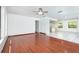 Open-concept living room that leads to the kitchen with abundant natural light and neutral paint at 7059 Quigley St, Englewood, FL 34224