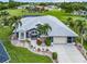 A beautiful single-story home showing the roof, front yard, landscaping and the surrounding neighborhood at 7130 Scarlet Sage Ct, Punta Gorda, FL 33955