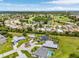 Expansive aerial view showcasing community, a golf course and surrounding green landscapes at 7130 Scarlet Sage Ct, Punta Gorda, FL 33955