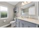 Bathroom with a marble countertop vanity, a window for natural light, and a shower at 7130 Scarlet Sage Ct, Punta Gorda, FL 33955