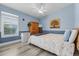 Cozy bedroom with blue walls, a ceiling fan, a window, and a closet with a wardrobe at 7130 Scarlet Sage Ct, Punta Gorda, FL 33955