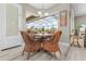 Breakfast nook with a large window with a view of the screened lanai, pool, and tropical trees at 7130 Scarlet Sage Ct, Punta Gorda, FL 33955