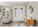Inviting foyer with decorative glass double doors, wood-look floors, and stylish decor at 7130 Scarlet Sage Ct, Punta Gorda, FL 33955