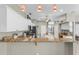 Well-lit kitchen area with granite countertops, stainless steel appliances, white cabinets, and an open view at 7130 Scarlet Sage Ct, Punta Gorda, FL 33955