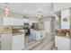 Spacious kitchen featuring granite counters, a central island, stainless steel appliances, and ample white cabinetry at 7130 Scarlet Sage Ct, Punta Gorda, FL 33955